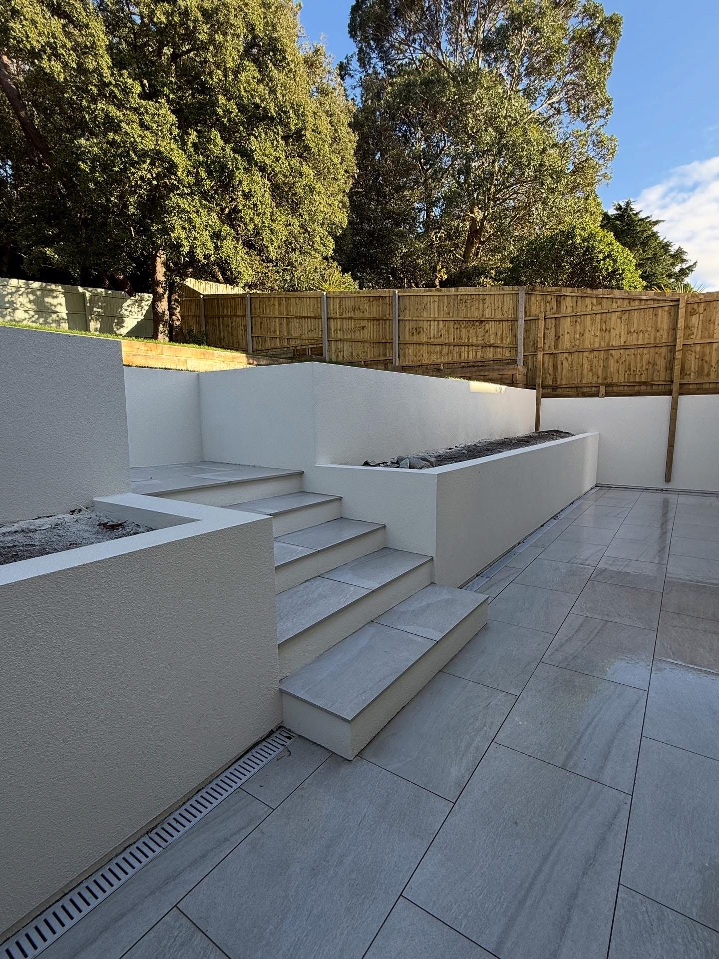 Rendered garden walls and porcelain steps completed by Holland Plastering